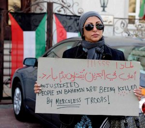 A Shia woman protests outside the Bahraini embassy in Kuwait. Photo courtesy of Ra'ed Qutena/Flickr.