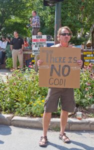 Atheist and Christians Hold Opposing Signs at the Bele Chere Fes
