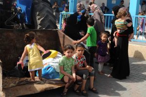 Palestinian families take shelter at an UNRWA school in Gaza City (13 July 2014). Photo: Shareef Sarhan/UNRWA