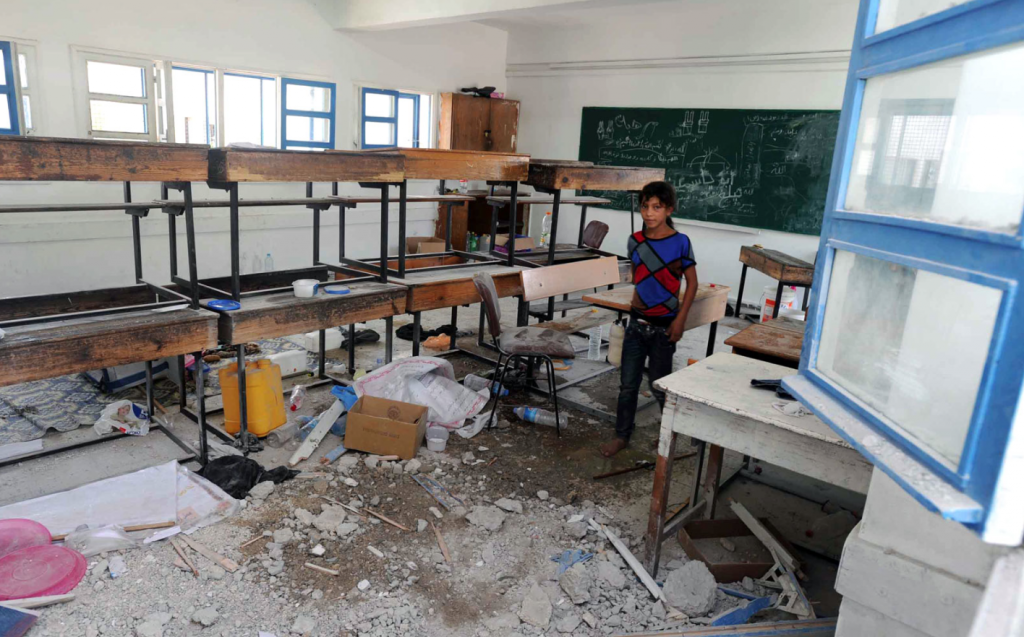 Ninety displaced people, on average, sleep in classrooms like this one that was struck by Israeli artillery shells. © Shareef Sarhan/UNRWA Archives