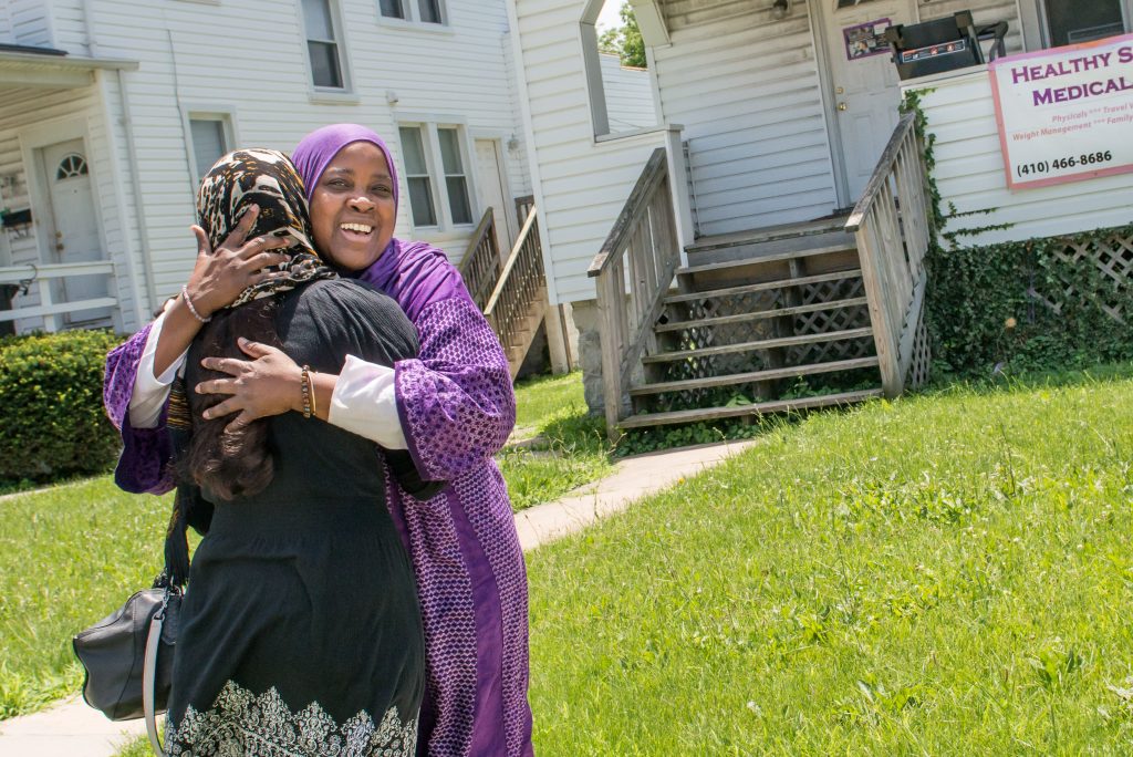 Hanif welcomes a new resident to this home in Baltimore, Md. "I like to call it a home, not a shelter," she says. Hanif has been striving for the past 27 years to provide a safe environment for Muslim women while empowering them through classes and programs. >Photos by Aeysha Chaudhry