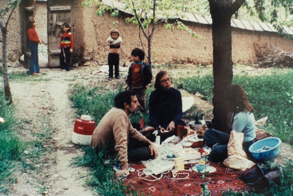 Powers spent her childhood years in the Middle East and Asia. Here are her parents, Richard and Helen Power, in a walled garden in Tehran, Iran. Carla's younger brother Nick stands with his arms crossed and Carla is standing on the left side of the door. >Photo courtesy of Carla Power