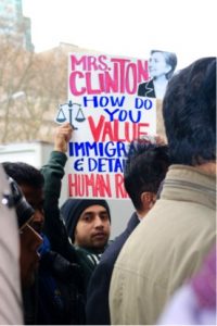 DRUM member’s sign asks, “Mrs. Clinton, how do you value immigrant & detainee human rights?” 