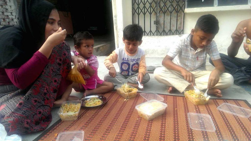 Dil Muhammad Rahman, Hasinah Izhar and their children share a meal together. Activist Mariam Mehter raised money for their family to help them through their hardship after a New York Times article was published detailing their journey to Malaysia.